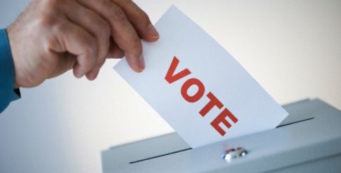 Man putting vote card into box